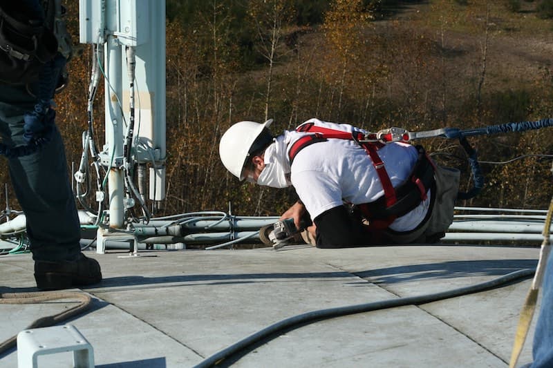 Cell tower antenna mounting plate bonded to water tank